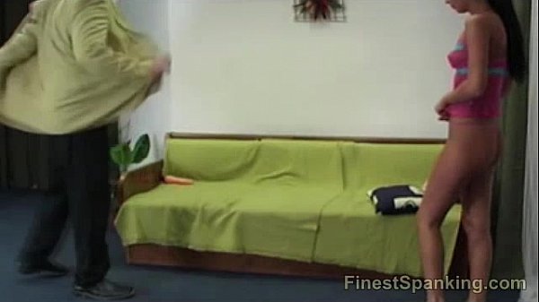 Mistress spanks a brunette